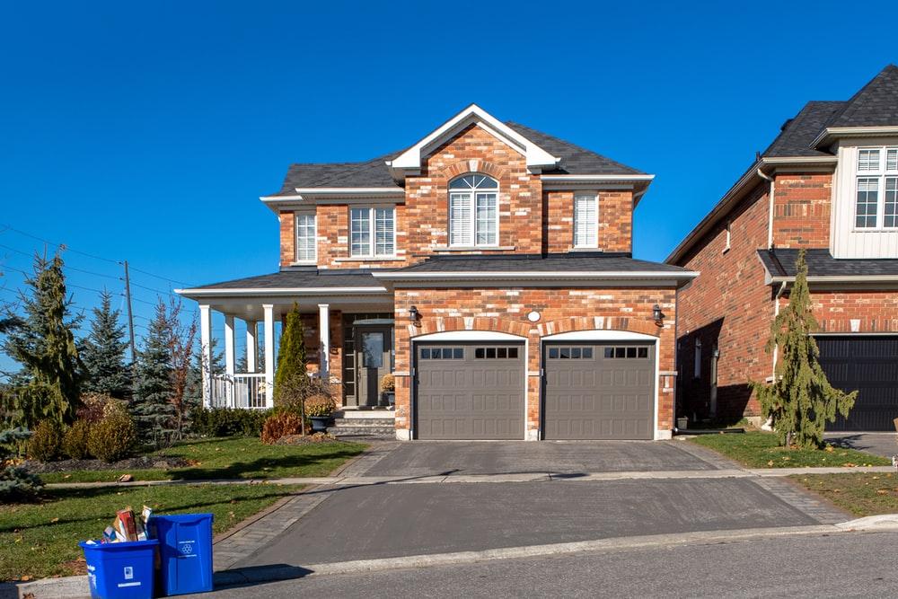 Common garage door problems addressed by us in a red brick home