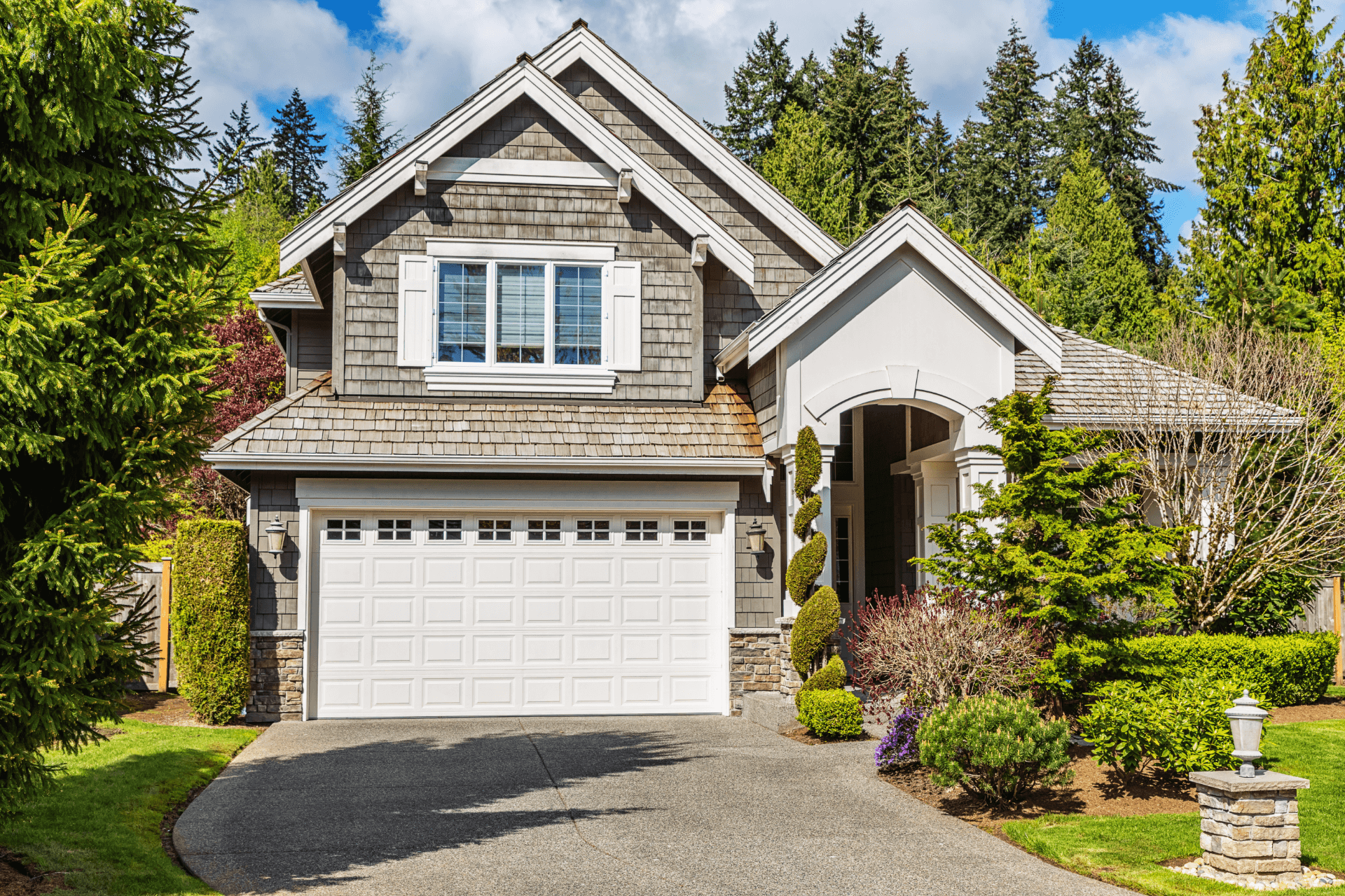 white garage door on rustic two-story home