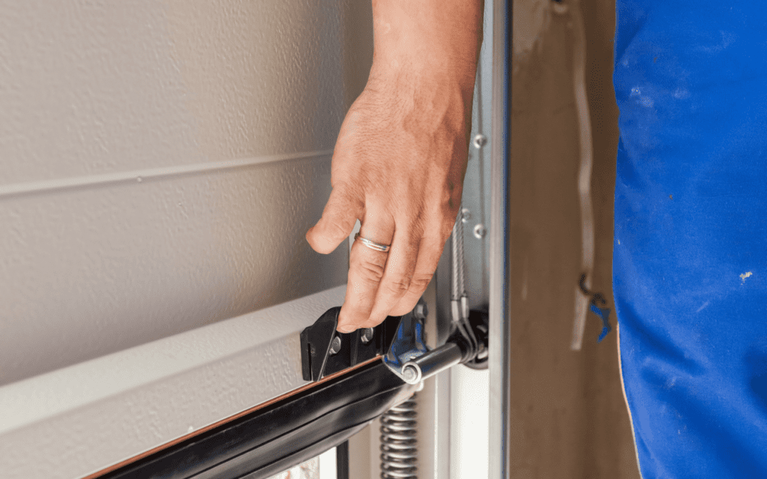 A man engages in garage door maintenance.