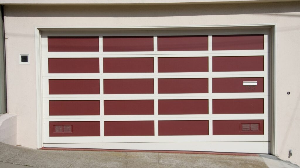 A garage freshly painted by a homeowner who learned how to paint a garage door